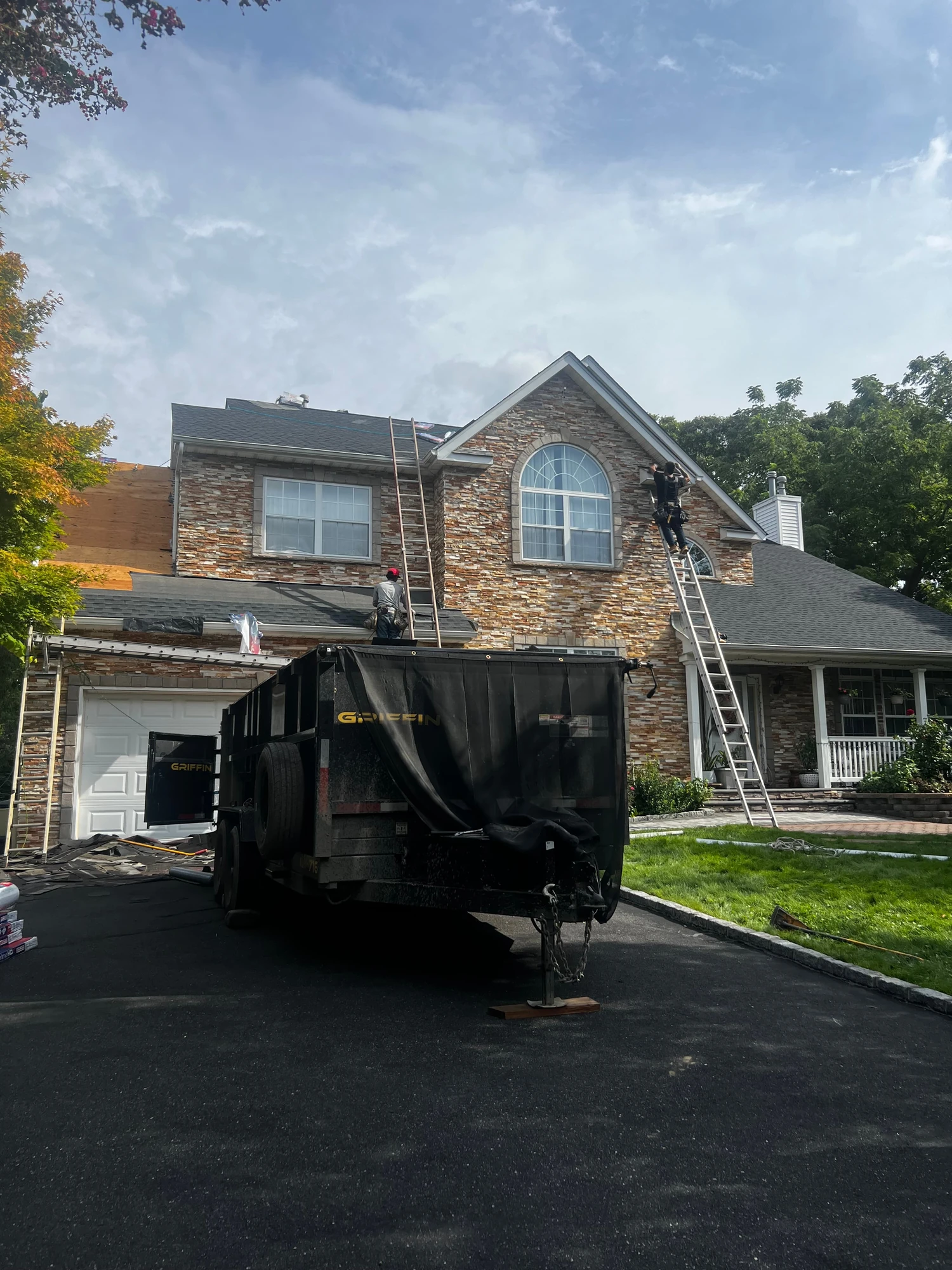 Roof renovation with debris container