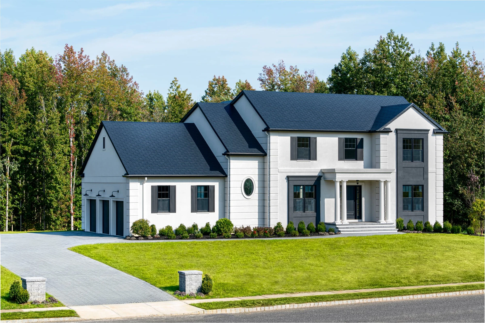 Black roof on a white modern farmhouse