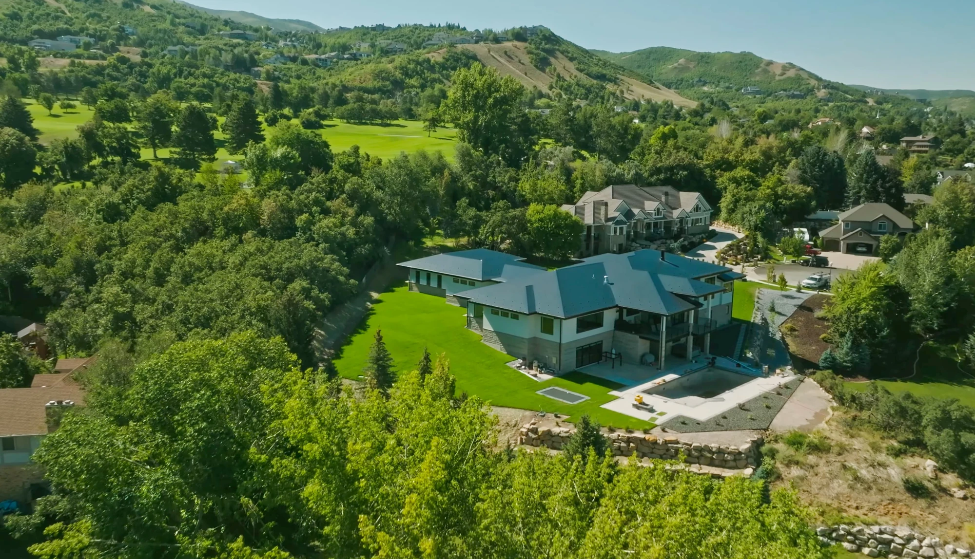 Teal estate roof in a wooded setting