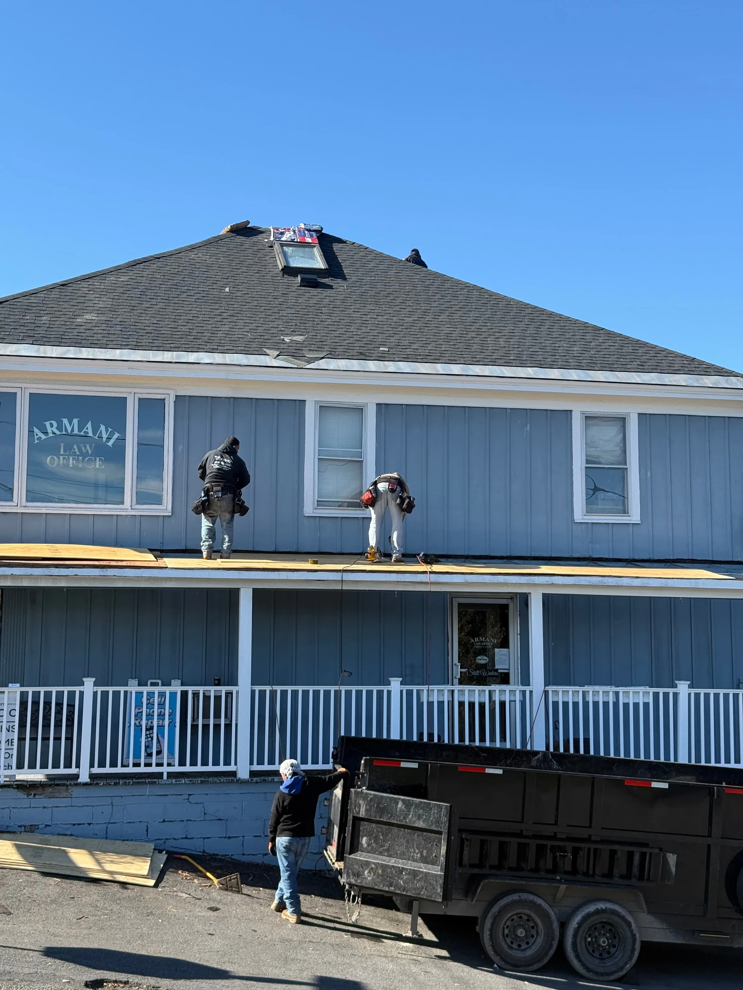 Roof on a blue two-story home